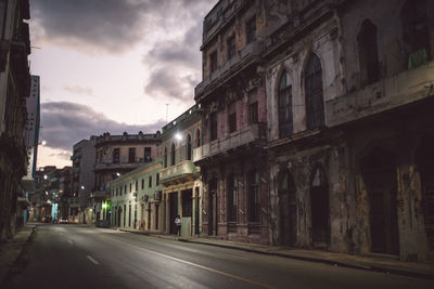 Street amidst buildings in city at night