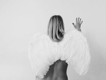 Woman holding hair over white background