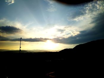 Silhouette landscape against sky during sunset