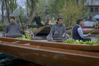 People sitting by plants