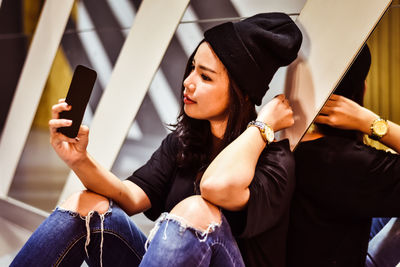 Midsection of woman using mobile phone