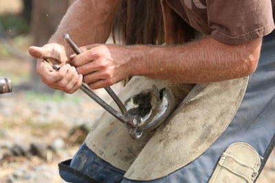 Farrier shoeing a horse 