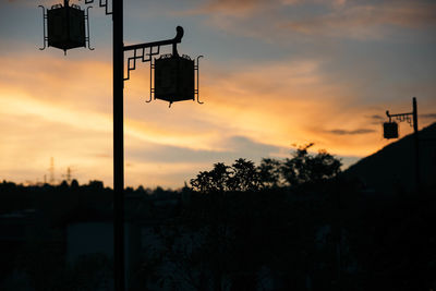 Silhouette trees against sky during sunset