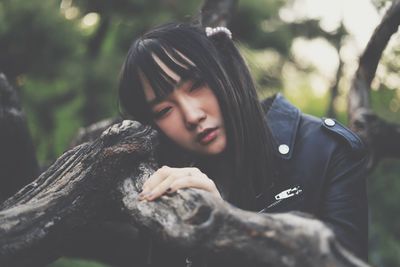 Portrait of smiling girl with tree trunk