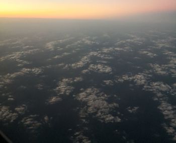 Aerial view of sea against sky at sunset