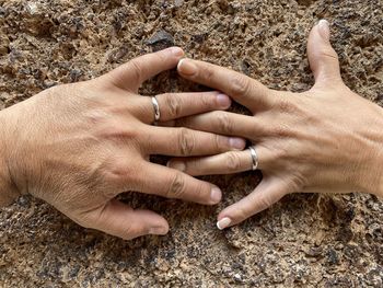 High angle view of hands touching feet