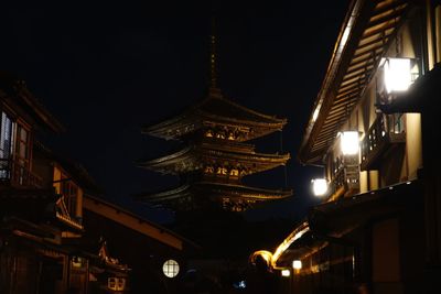 Low angle view of illuminated buildings at night