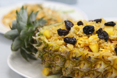 Thai pineapple fried rice with the pineapple, cashew nut, egg and raisin on top