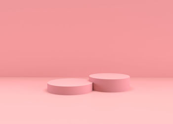 Close-up of pink candle on table against wall
