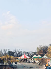 Tent by trees against sky