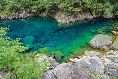 High angle view of rocks by sea