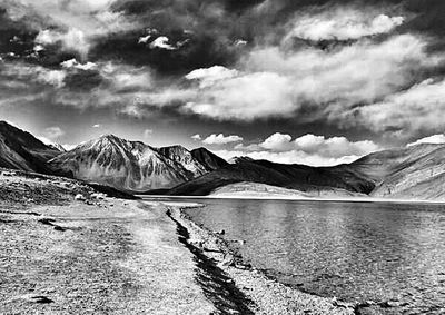 Scenic view of lake against cloudy sky