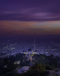 High angle view of buildings in city at night
