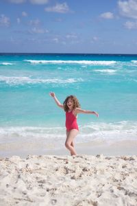 Girl standing at beach during summer