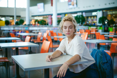 Woman sitting on chair at supermarket