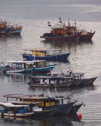 Boats sailing in sea against sky