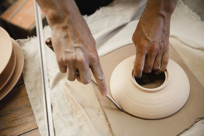 Midsection of man working at workshop