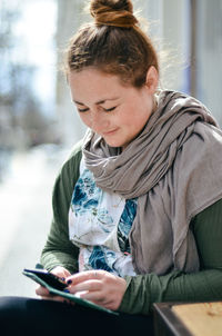 Mid adult woman using mobile phone in winter