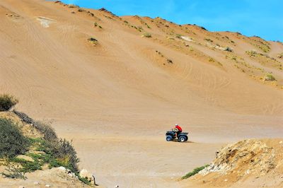 Man riding at bike in desert