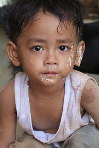 Close-up portrait of cute boy with messy face