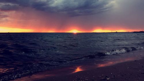 Scenic view of sea against cloudy sky