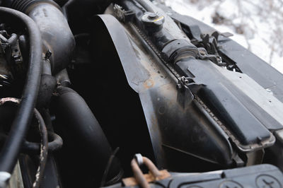 View under the hood of the car. close-up of a v-shaped six-cylinder old engine. dirty engine. time