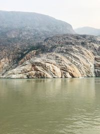 Scenic view of sea and mountains against sky