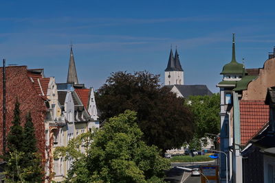 Panoramic view of buildings in city against sky