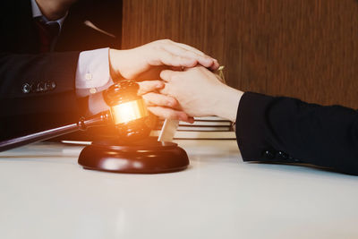 Close-up of hands working on table