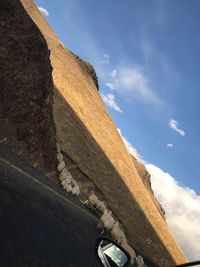 Low angle view of mountain against blue sky