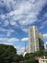 Low angle view of buildings against cloudy sky