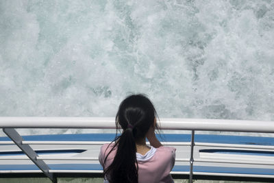 High angle view of girl traveling on boat at sea