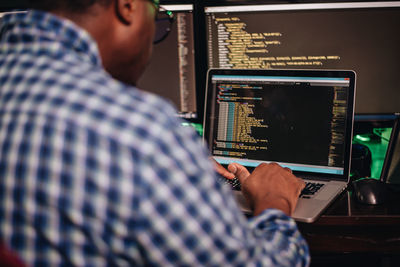 Close-up of computer programmer working at office