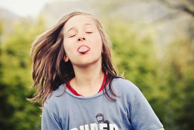 Close-up of child sticking out tongue