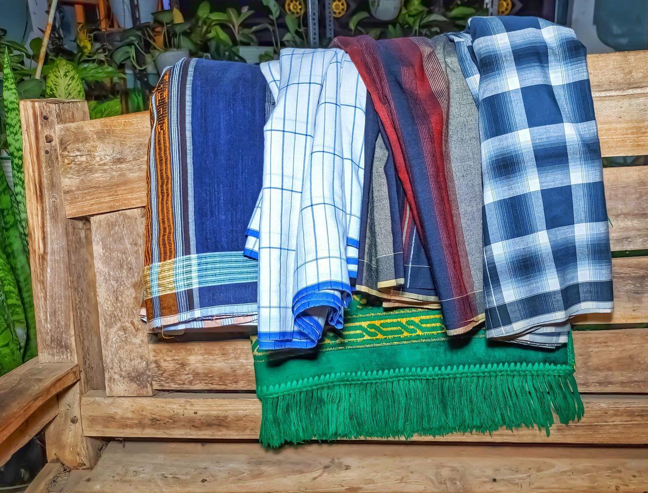 blue, wood, no people, clothing, textile, day, towel, seat, green, multi colored, nature, chair, striped, outdoors, plant, furniture, high angle view, art