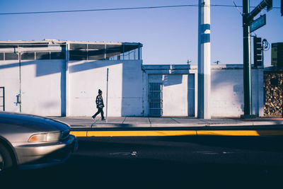 Man walking on road in city