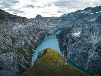 Two friends watching the sunset over the limmerensee near the muttseehütte in the swiss alps.