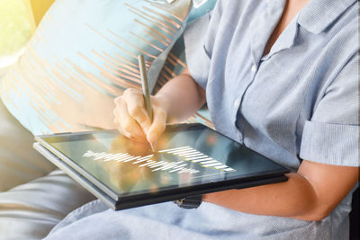 Midsection of man using laptop