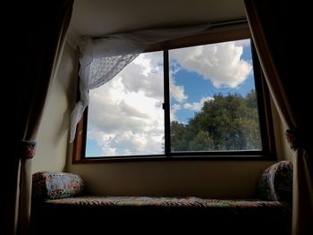 Cloudy sky seen through window at home