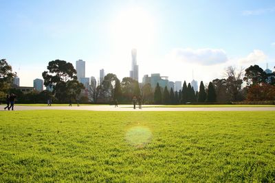 Scenic view of field in park against sky