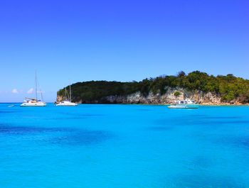 Scenic view of sea against clear blue sky