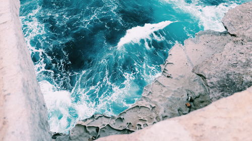 High angle view of rocks in sea