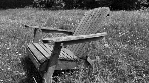 Empty bench on field in park