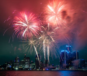 Low angle view of firework display at night