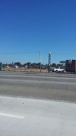 View of road against clear blue sky