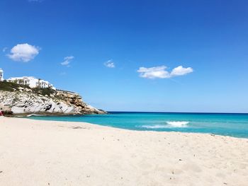 Scenic view of beach against blue sky