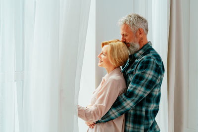 Man and son standing on window