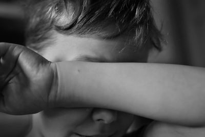 Close-up of boy crying at home