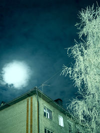 Low angle view of illuminated building against sky