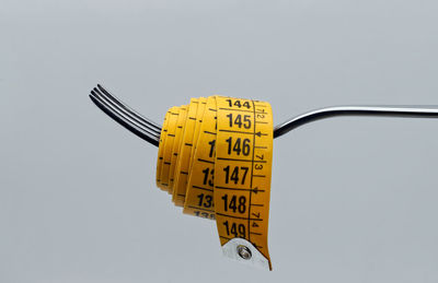 Low angle view of information sign against clear sky